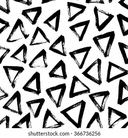 Seamless pattern with hand drawn triangles. Vector seamless pattern with black hand drawn triangles on white background. Graphical hand drawn background.