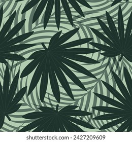 Seamless pattern with hand drawn tropical palm leaves on green background.