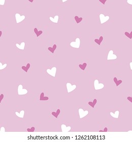 Seamless pattern of hand drawn white and dark pink hearts on a light pink background for valentines day concept