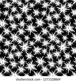 Seamless pattern with hand drawn white flowers on the black background. Flowers doodles were drawn by hand with a pen. Black and white background. Abstract floral design.