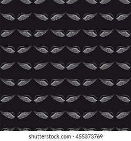 Seamless pattern with hand drawn white wings on the black background. Vector illustration