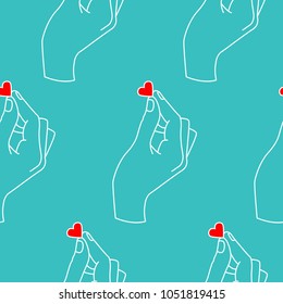 Seamless pattern with hand and heart.