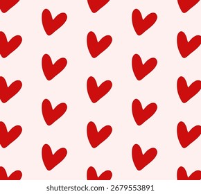 Seamless pattern with hand-drawn red hearts on a light pink background. This charming vector illustration, with its simple doodle style, is perfect for wrapping paper, textile prints, Valentine's Day 