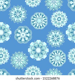 Seamless pattern with hand-drawn winter mandalas on blue background