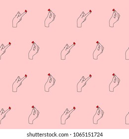 Seamless pattern with hands and hearts on pink background.