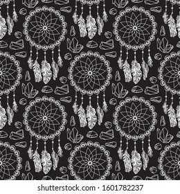 Seamless pattern with hanging Dreamcatcher. Beautiful Hand drawn white catchers with feathers isolated on black background. Magic or mystery fairytale symbol. Ethnic art. Vector illustration