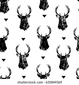 Seamless pattern with the head of a deer and triangles. Ornament for textile and wrapping. Vector.