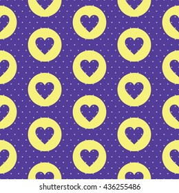 Seamless pattern with a heart shape inside the circle and polka dot background. Soft yellow and dark blue colors.