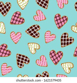 Seamless pattern with heart shaped cookies with sugar icing on a blue background. Cute vector illustration