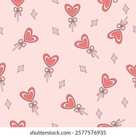 Seamless pattern with heart shaped
lollipop on pink background.