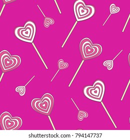 Seamless pattern of heart shaped lollipops on a purple background