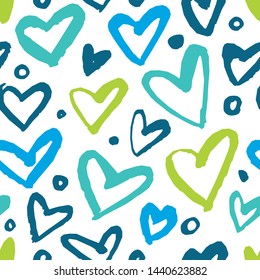Seamless pattern with hearts in blue colors. Draw a dry brush.