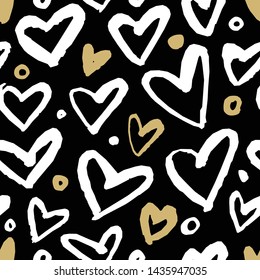 Seamless pattern with hearts of gold and white on a black background. Hand-drawn ink.