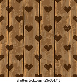 Seamless pattern with hearts and on a retro wooden boards background