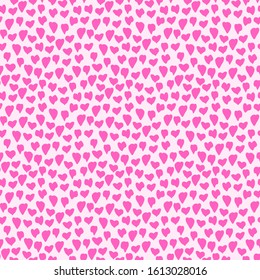 Seamless pattern with hearts. Pink hearts confetti on light pink backgrounds. Love texture. Cute symbols of St. Valentine, love and marriage for your design. Vector Illustration.