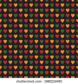 Seamless pattern with hearts in traditional Pan African colors - red, yellow, green, black background. Backdrop for Kwanzaa, Black history month, Black Love Day, Juneteenth greeting card, poster