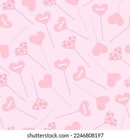 Seamless pattern with heart-shaped toppers with different patterns randomly scattered on a pink background in vector