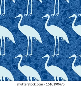 Seamless pattern with herons. Silhouette of a Heron on a blue background.