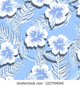 Seamless pattern with hibiscus flowers and palm leaves.