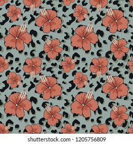 Seamless pattern with hibiscus flowers and print skins of an exotic animal.