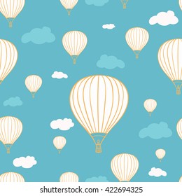 Seamless pattern with hot air balloons and clouds on the blue background.White hot air balloons with yellow outline. Blue background with white and blue clouds.