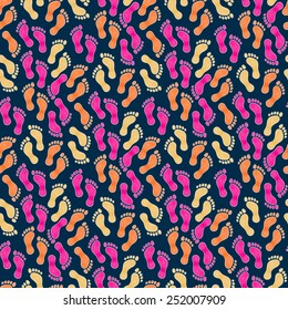 Seamless pattern with human footprints in pink, orange, yellow, white colors on a dark background