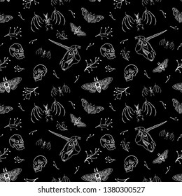 Seamless pattern. Human skull, bat skeleton and unicorn skull among branches. Black and white ornament. Illustration for Halloween.