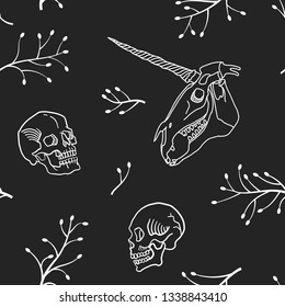 Seamless pattern. Human skull and unicorn skull among branches. Hand drawn illustration for Halloween.