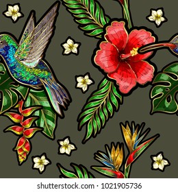 Seamless pattern with humming bird embroidery patches, hibiscus flowers and tropical leaves. 