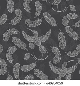 Seamless pattern with hummingbirds and feathers light contour drawings on a dark background