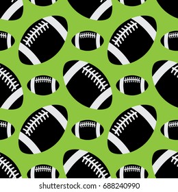 seamless pattern illustration - black and white american football balls, different sizes, in front of a green background