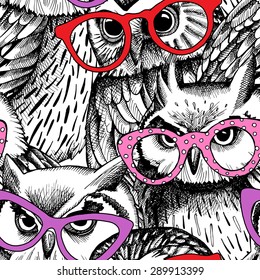 Seamless pattern with the image of black and white owls in red, pink, violet glasses. Vector illustration.