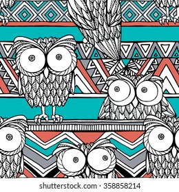 Seamless pattern with image of decorative owls on a brown and green geometric ornament. Vector illustration.