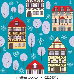 seamless pattern with the image of old town houses, trees and snowflakes. winter cityscape.