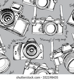 Seamless pattern with images of a black and white cameras on gray background. Vector illustration.