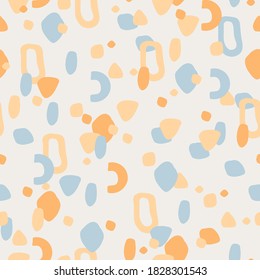 Seamless pattern imitating the Venetian Terrazzo. Modern abstract background of spots and different shapes in yellow and blue colors on a light background. Minimalistic trend background