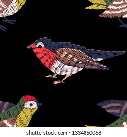 Seamless pattern. Imitation of embroidery. Embroidered birds. Satin stitch. Bird embroidered with stitches. Black background. Hand drawn. Vector illustration.