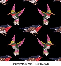 Seamless pattern. Imitation of embroidery. Embroidered birds. Satin stitch. Bird embroidered with stitches. Isolated on black background. Hand drawn vintage ornament. Vector illustration.