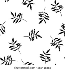 Seamless pattern with imprints of plants. black silhouettes of branches on a white background.