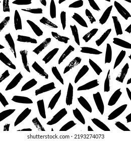 Seamless pattern with irregular black dashes. Simple geometric texture with short brushstrokes. Abstract background in Memphis style. Ink painted hand made texture. Vector black ink ornament.