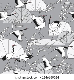 Seamless pattern with Japanese cranes and reeds on gray background. Endless texture decoration in oriental style with black and white simple plants and birds. Vector flat illustration. 