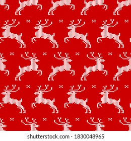 Seamless pattern with knit deers and snowflakes on red background. Christmas print for clothing, kitchen textiles and wrapping paper.