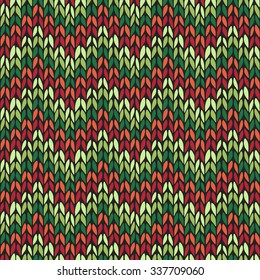 Seamless pattern with knitted chevron ornament. Christmas colors. Vector illustration