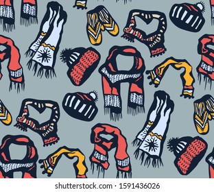Seamless pattern with knitted mittens, scarf and hats. Ornamental decorative background. Vector pattern. Print for textile, cloth, wallpaper, scrapbooking