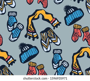 Seamless pattern with knitted mittens, scarf and hats. Ornamental decorative background. Vector pattern. Print for textile, cloth, wallpaper, scrapbooking