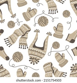 Patrón sin inconvenientes con ropa de punto caliente, mitones, medias, bufanda y sombrero sobre fondo blanco. Diseño invernal de temporada. Adecuado para textiles, tela, papel pintado, envoltura. Ilustración vectorial.