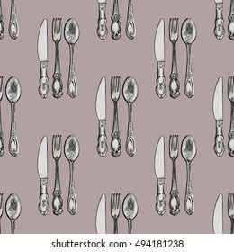 Seamless pattern with knives, forks and spoons . Hand drawn abstract background.