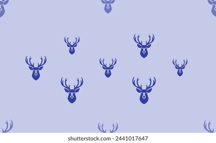 Seamless pattern of large isolated blue deer head symbols. The pattern is divided by a line of elements of lighter tones. Vector illustration on light blue background