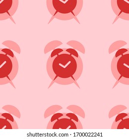 Seamless pattern of large isolated red alarm clock symbols. The elements are evenly spaced. Vector illustration on light red background