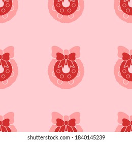 Seamless pattern of large isolated red christmas wreath symbols. The elements are evenly spaced. Vector illustration on light red background